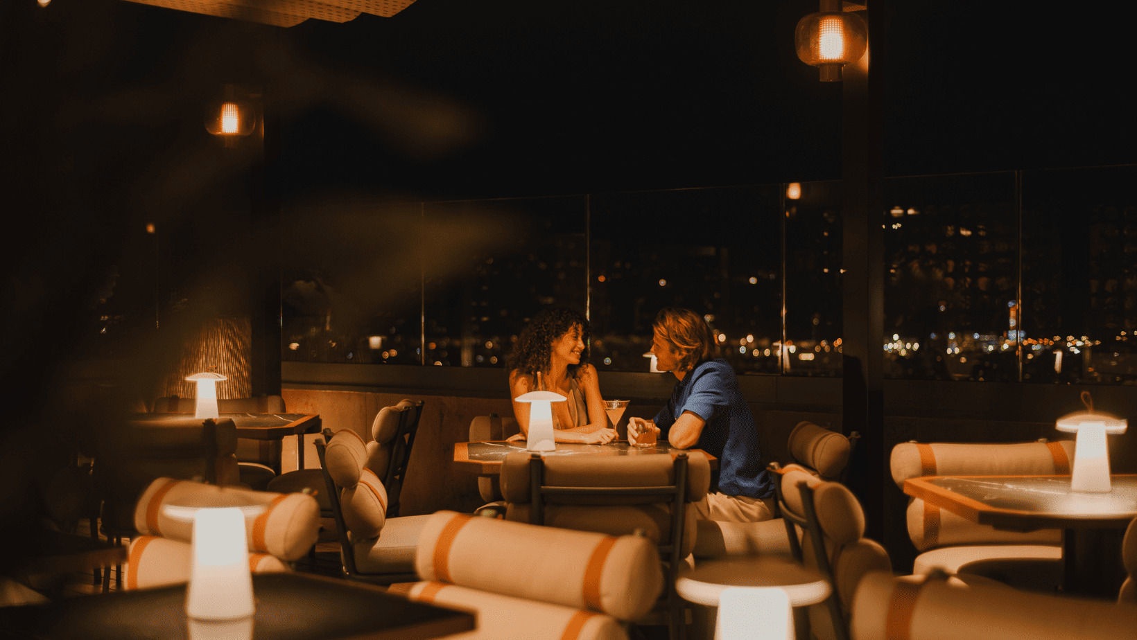 Couple enjoying a drink at night in a restaurant