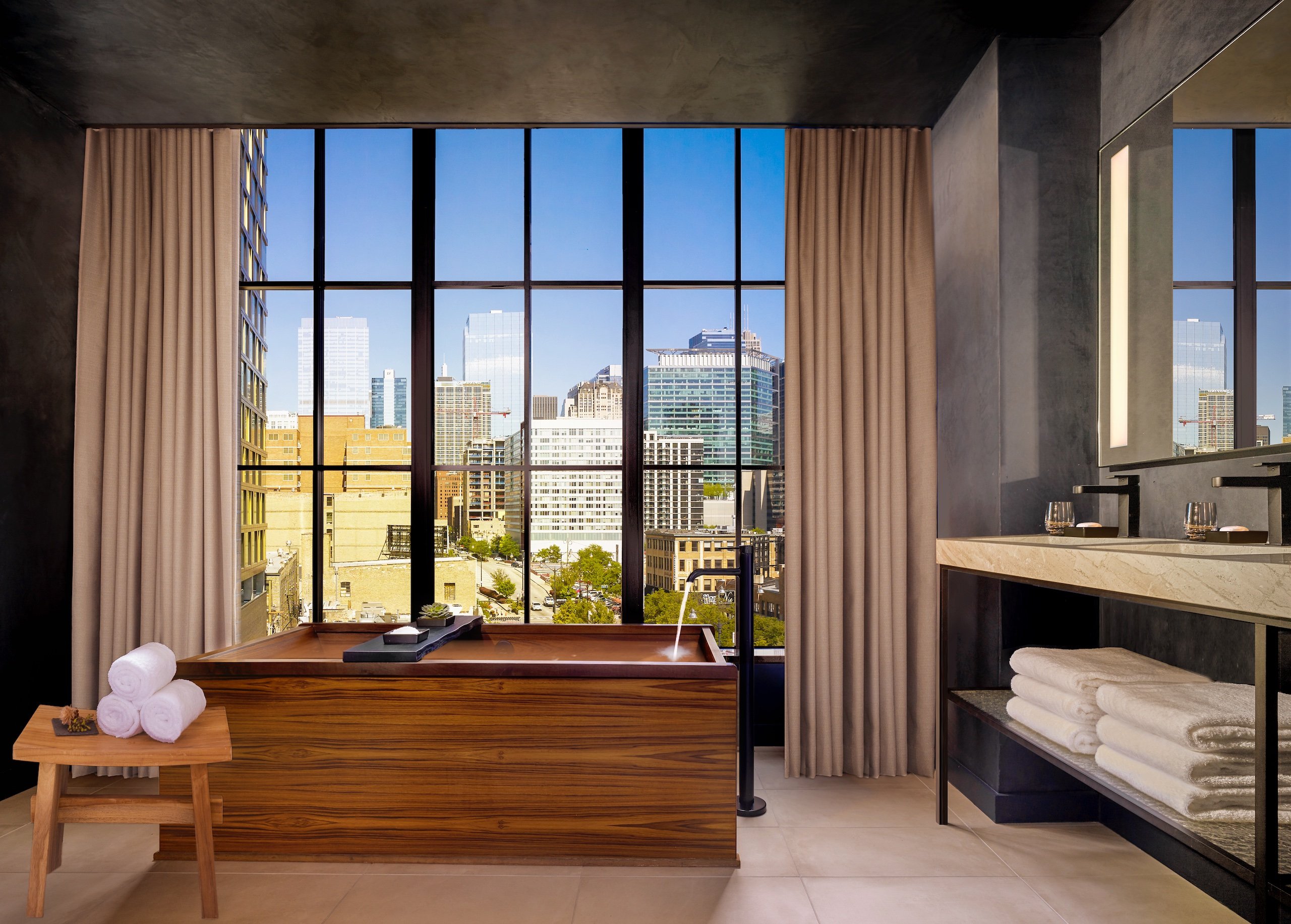 bathroom with a wooden tub in front of a large window