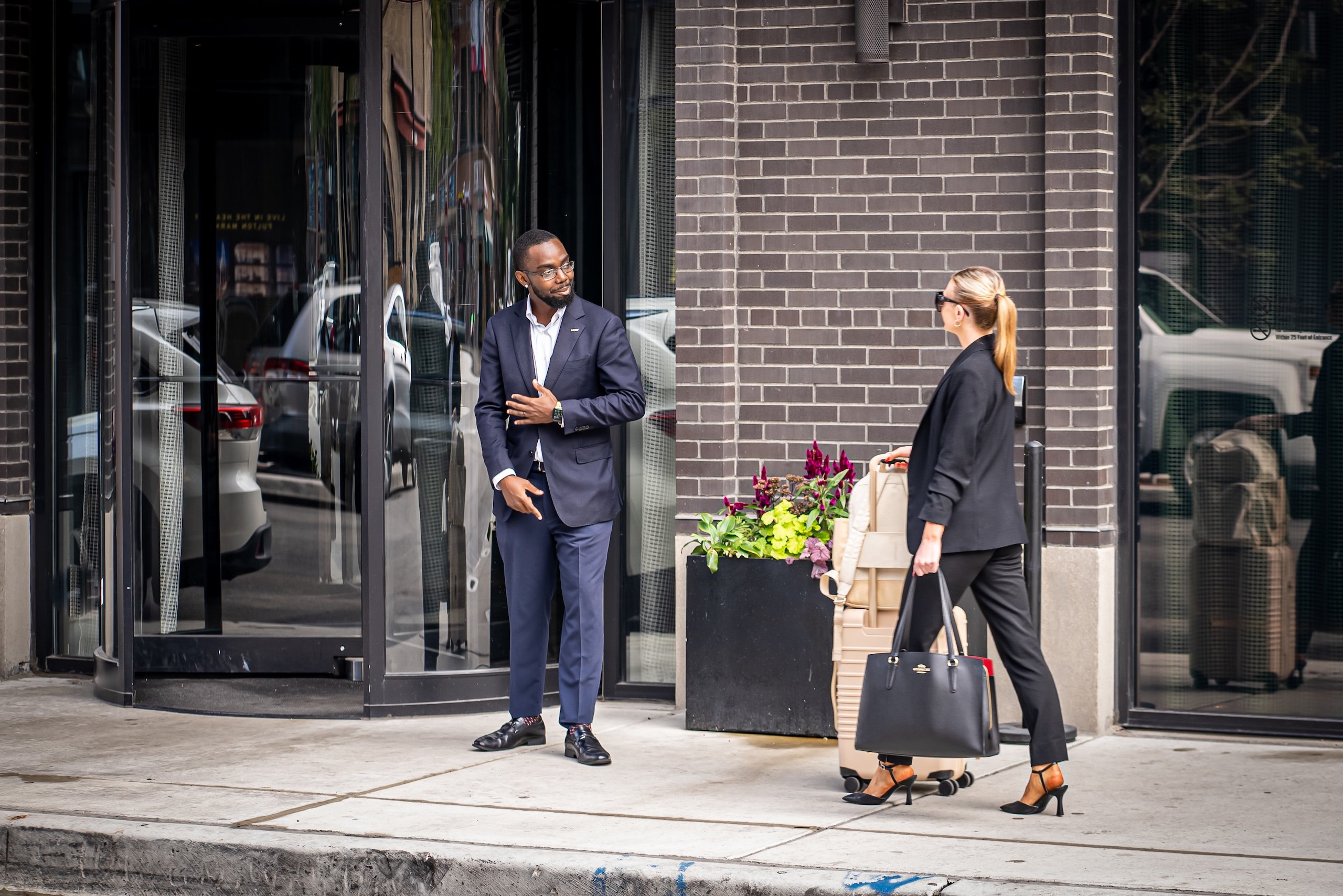 woman with luggage walking towards the entrance