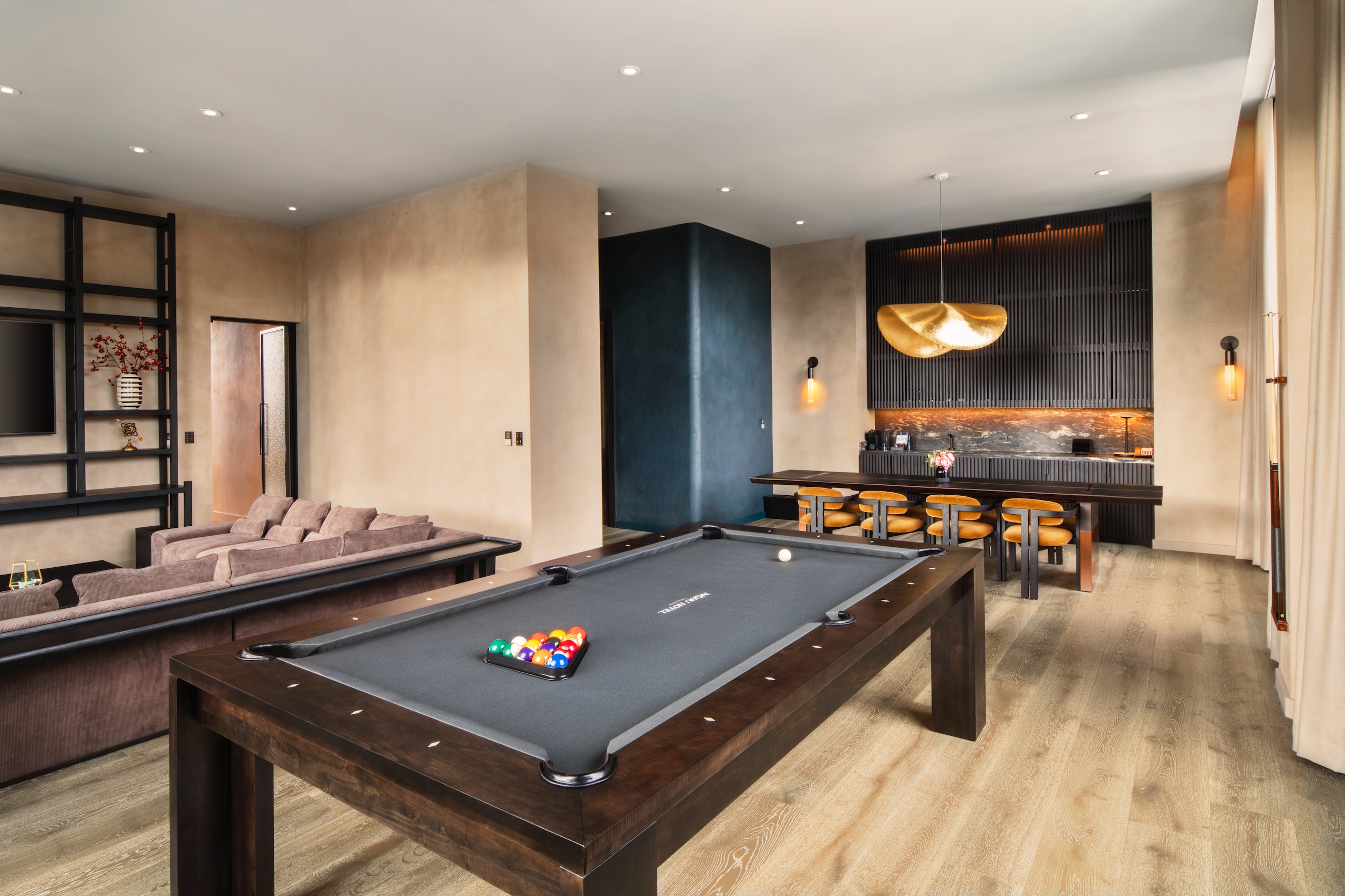 living room with large brown sectional and a dark wood pool table