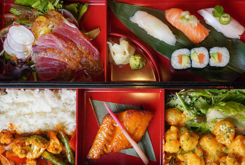 A vibrant red tray filled with an assortment of delicious foods, showcasing a colorful spread of snacks and treats