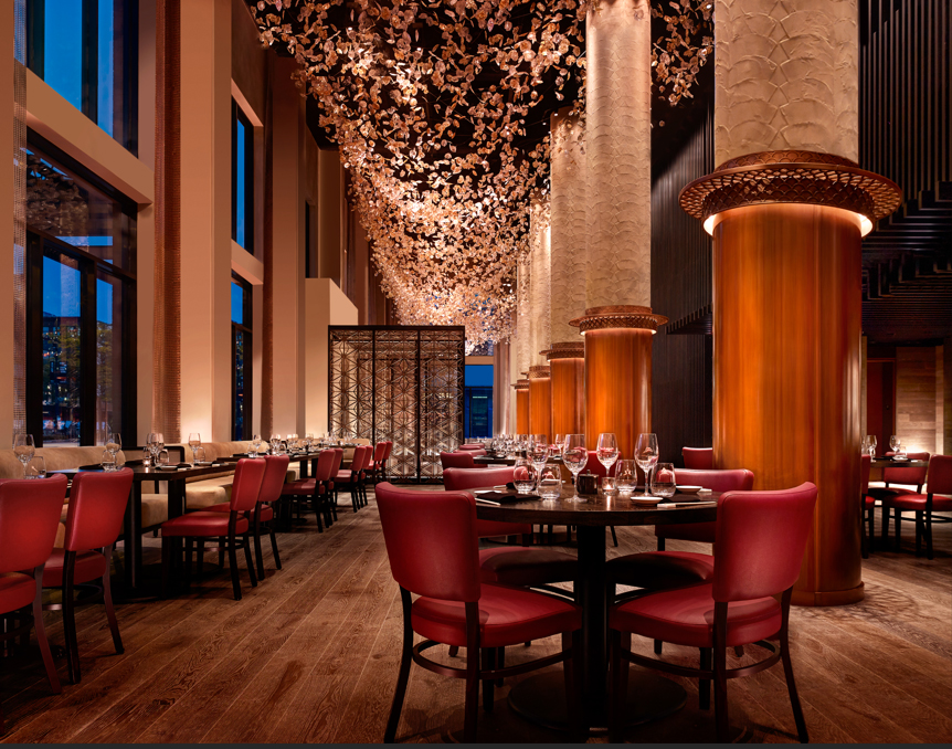 Charming dining spot with eye-catching red chairs and sparkling chandeliers adorning the ceiling