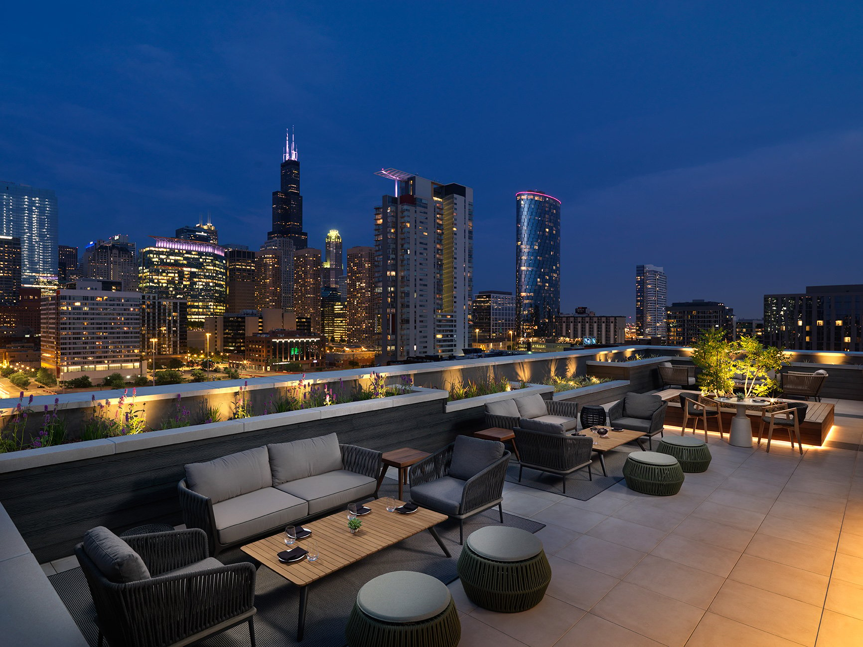 Nobu Chicago's rooftop patio, showcasing cozy seating and a beautiful skyline backdrop