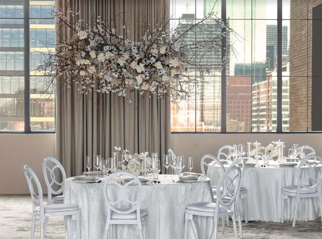 Elegant wedding reception held in a large room, featuring breathtaking views of the city skyline