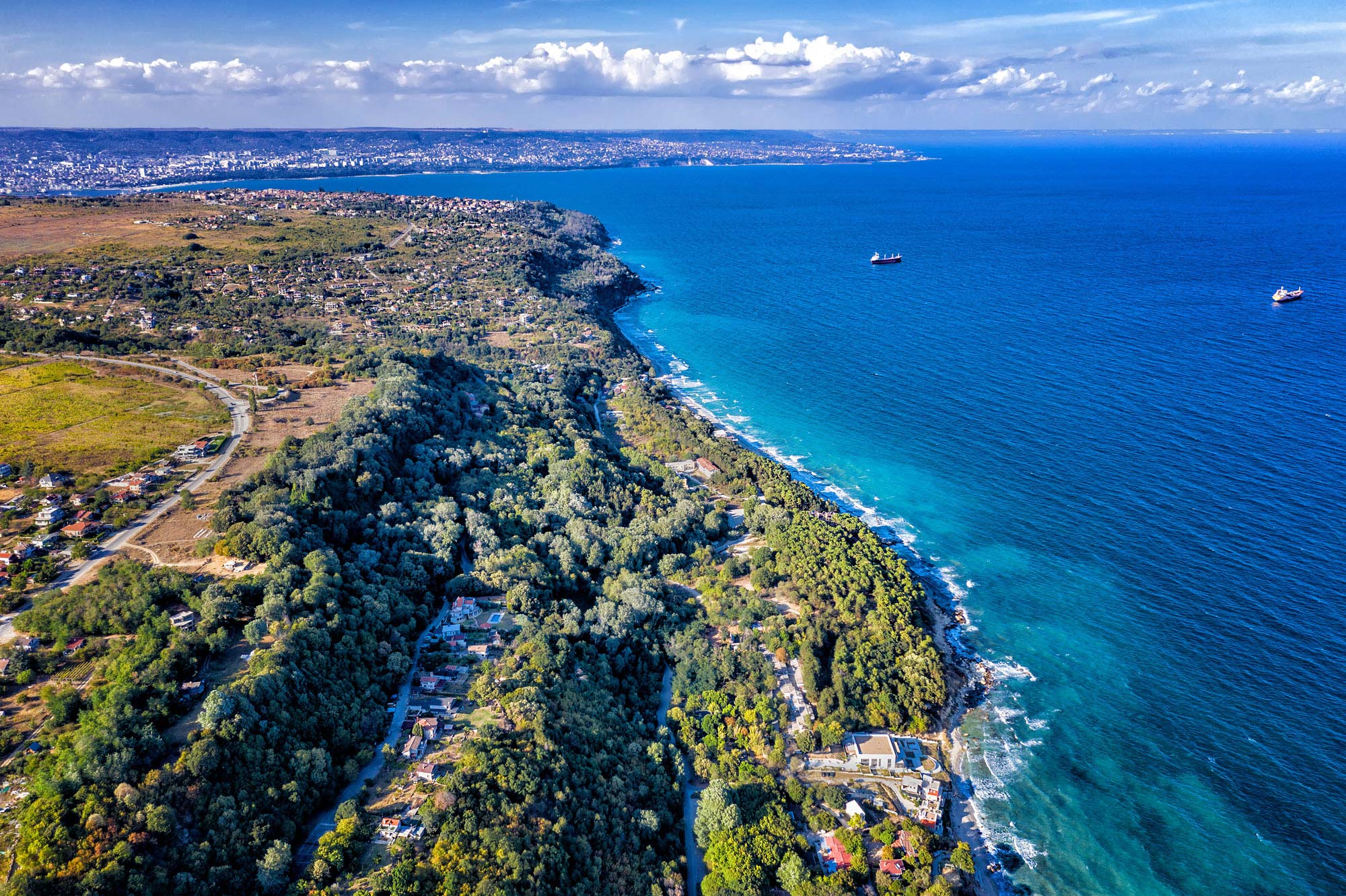 Aerial view showcasing the stunning coastline with vibrant blue sea meeting sandy shores