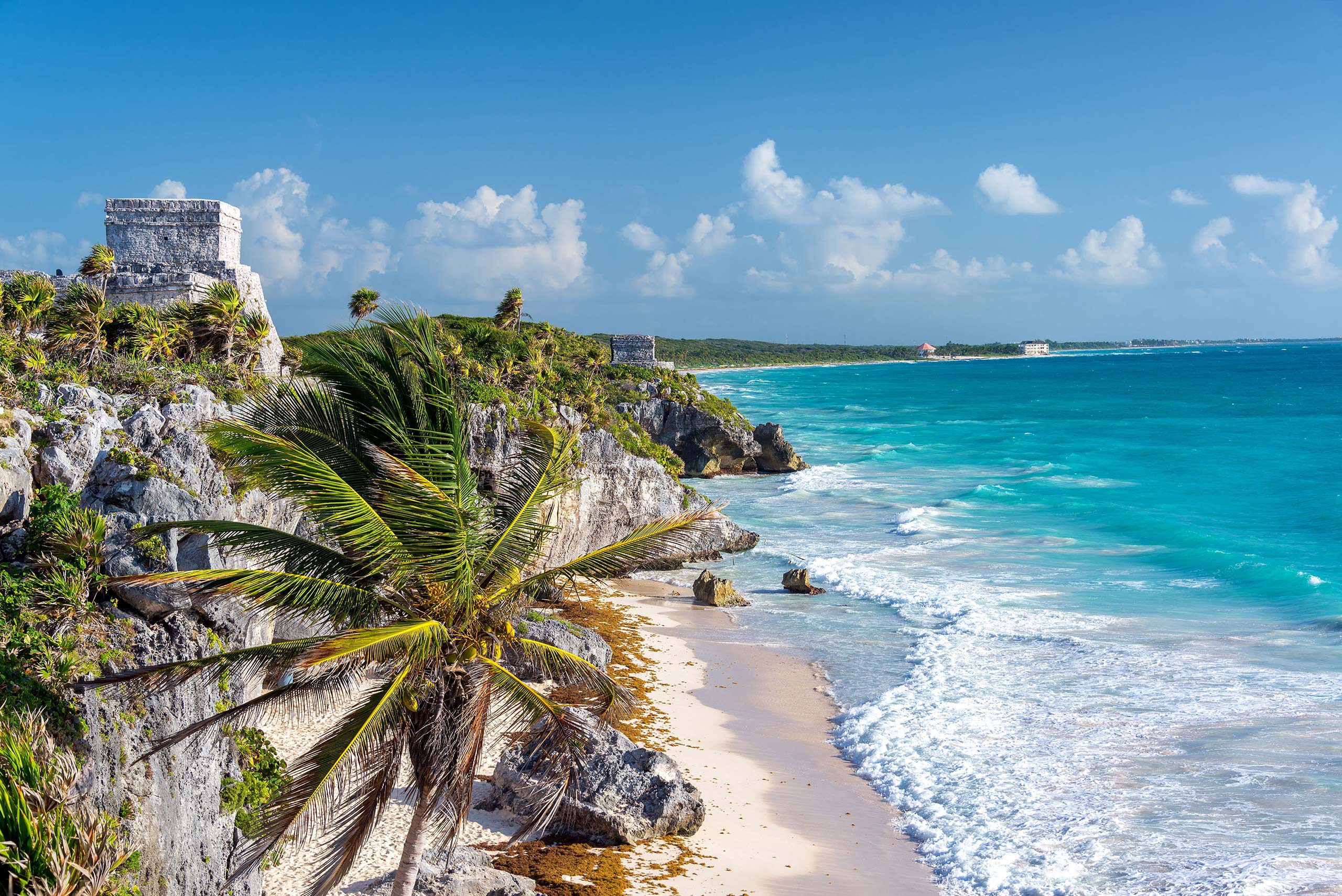 A vibrant view of Tulum, Mexico, showcasing its stunning beaches and ancient ruins under a clear blue sky