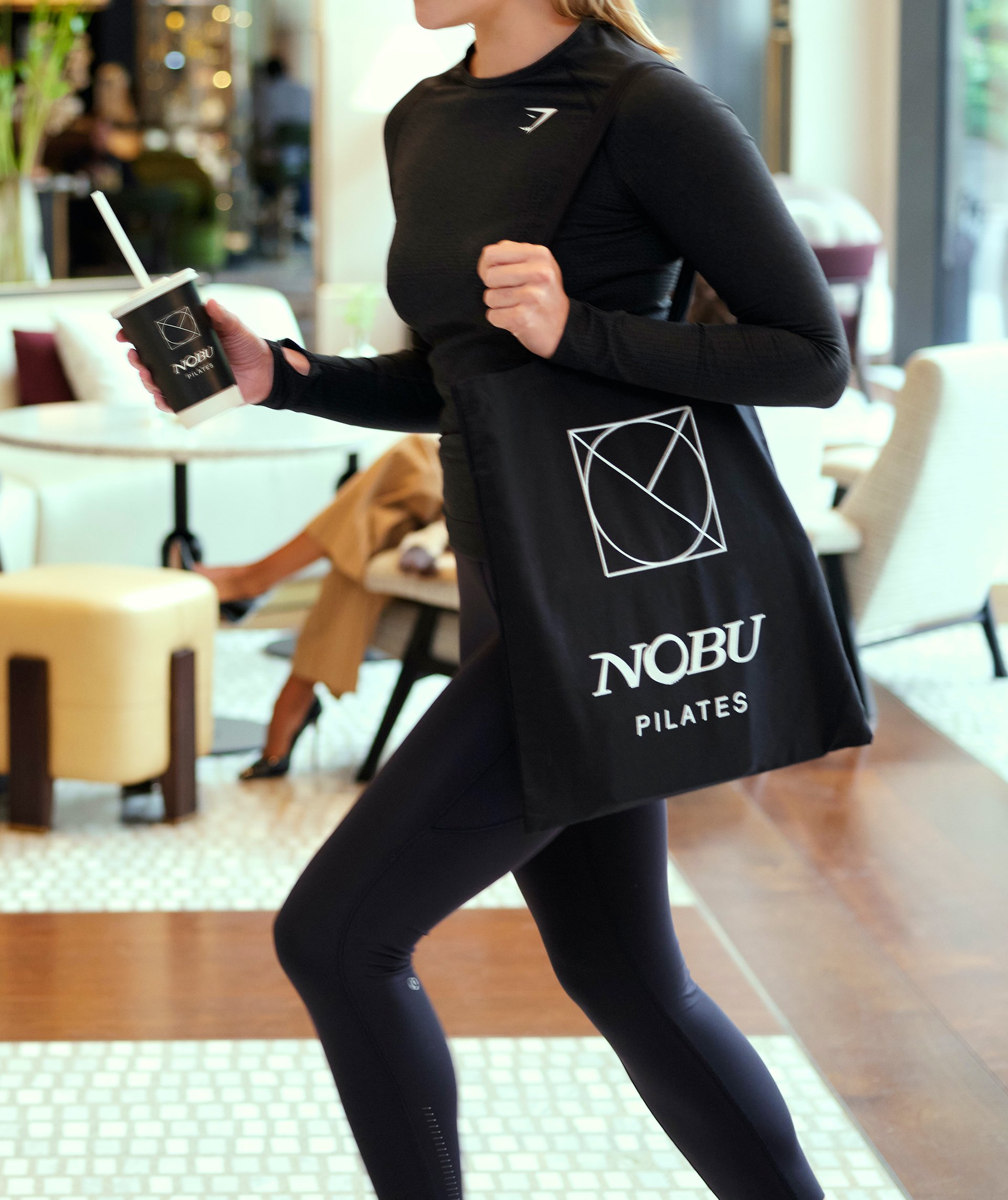 Lady with training clothes and nobu pilates bag