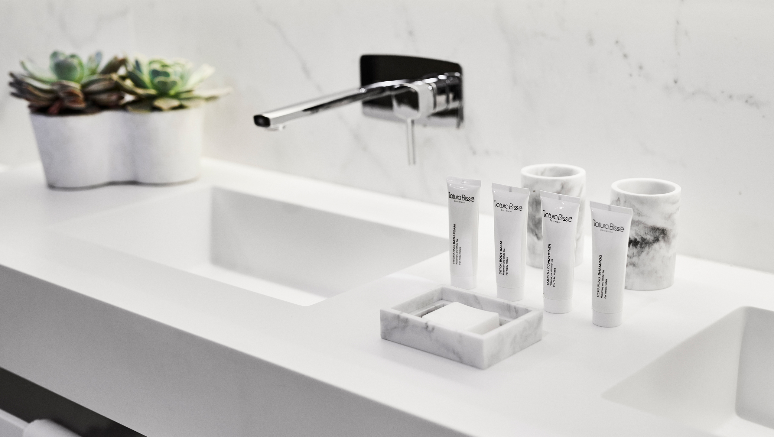 Elegant bathroom sink with a pristine white marble countertop, enhancing the room's modern aesthetic