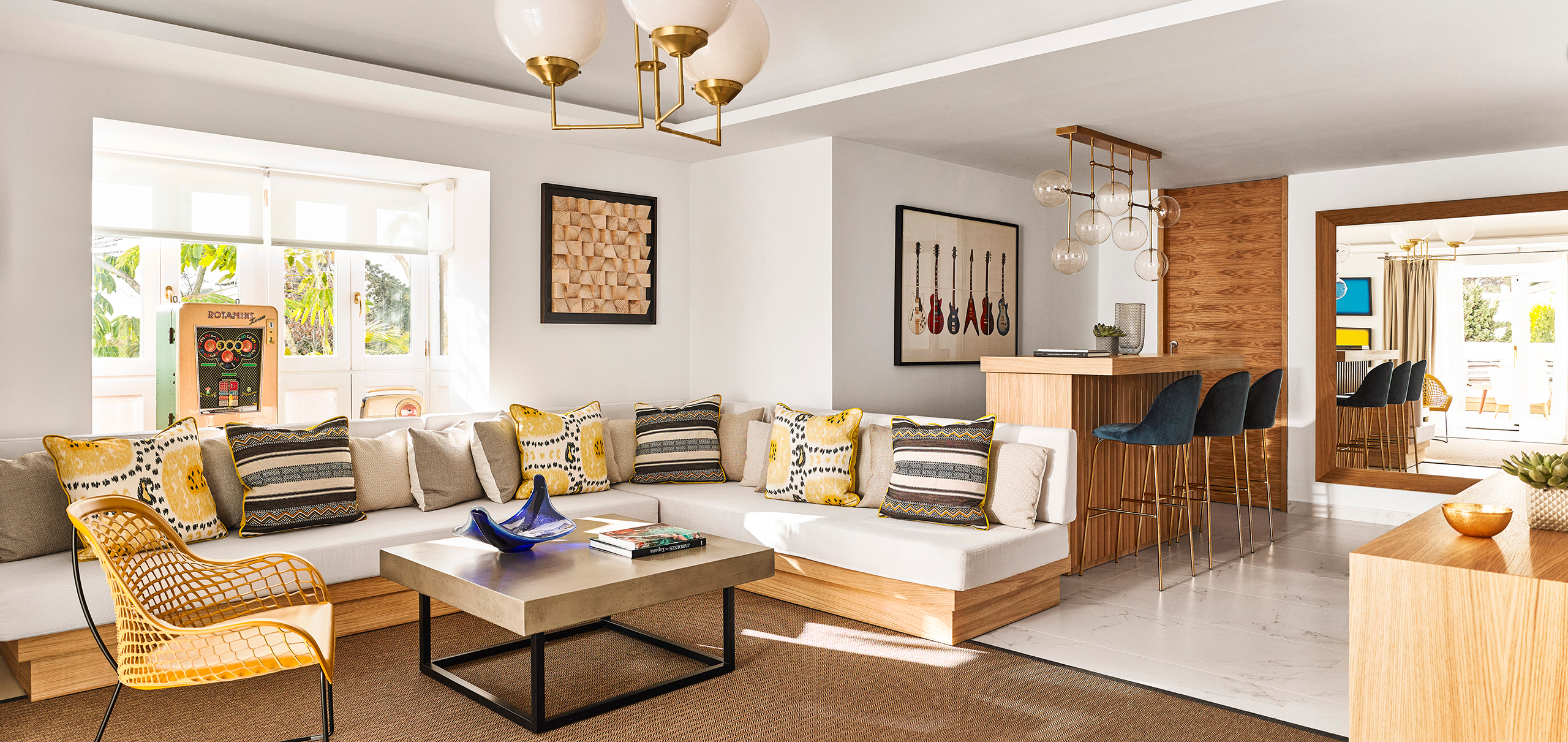 Stylish living room showcasing a soft couch, elegant coffee table, and a well-equipped bar for casual gatherings