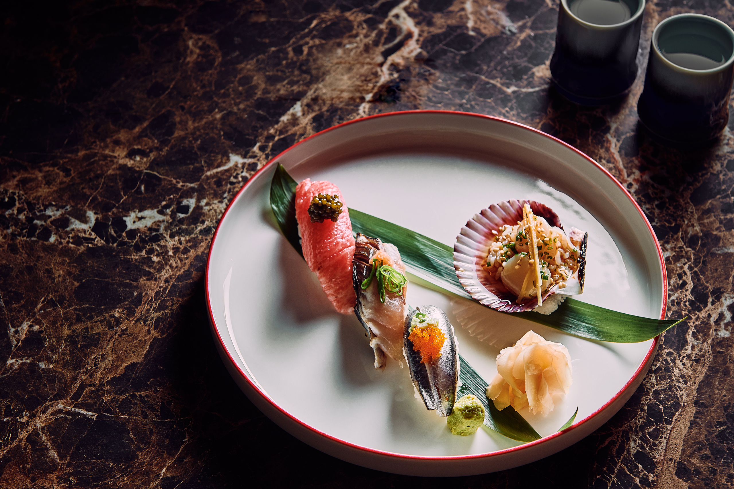 A colorful sushi plate featuring various sushi rolls and complementary dishes, beautifully arranged for a delightful meal