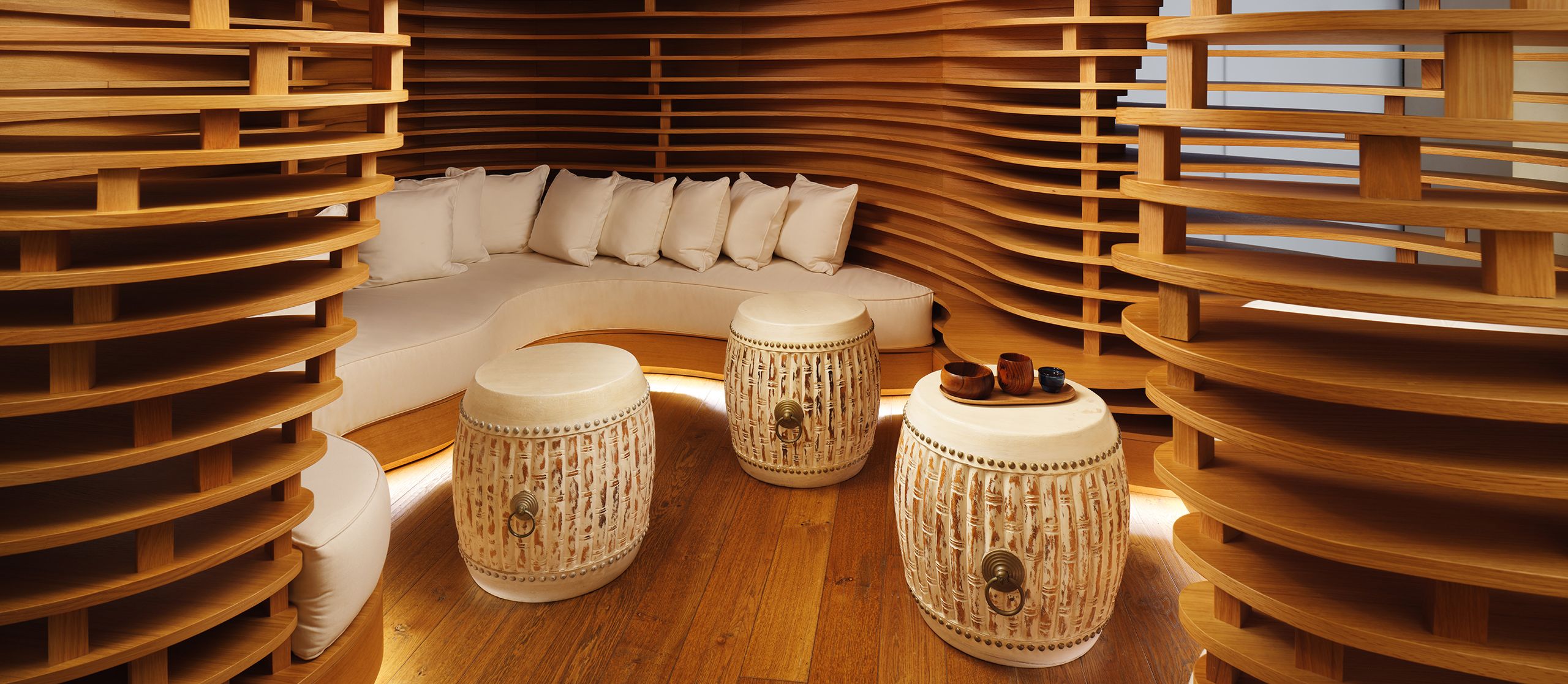 Cozy spa waiting area with natural wooden walls and floor, creating a calming atmosphere for guests to unwind