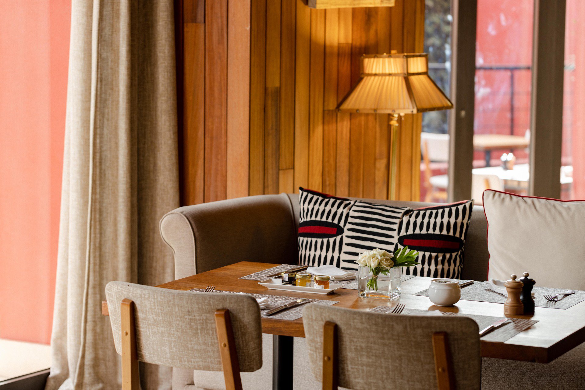 A simple wooden table accompanied by a single chair, creating a cozy and inviting space for dining or work.