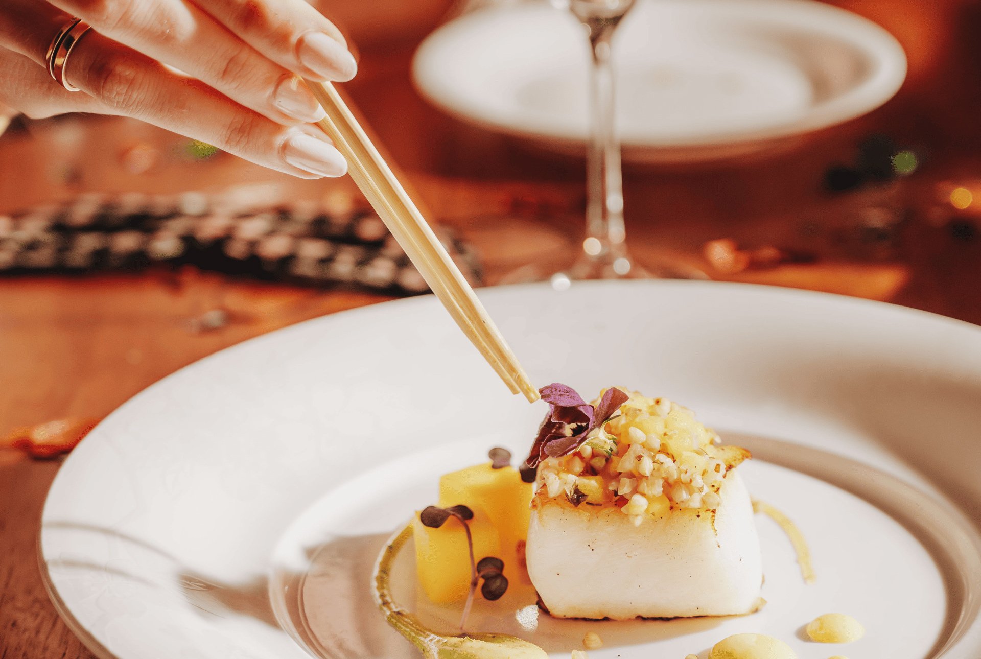 A person holds a fork above a delicious dish, ready to enjoy a tasty meal.