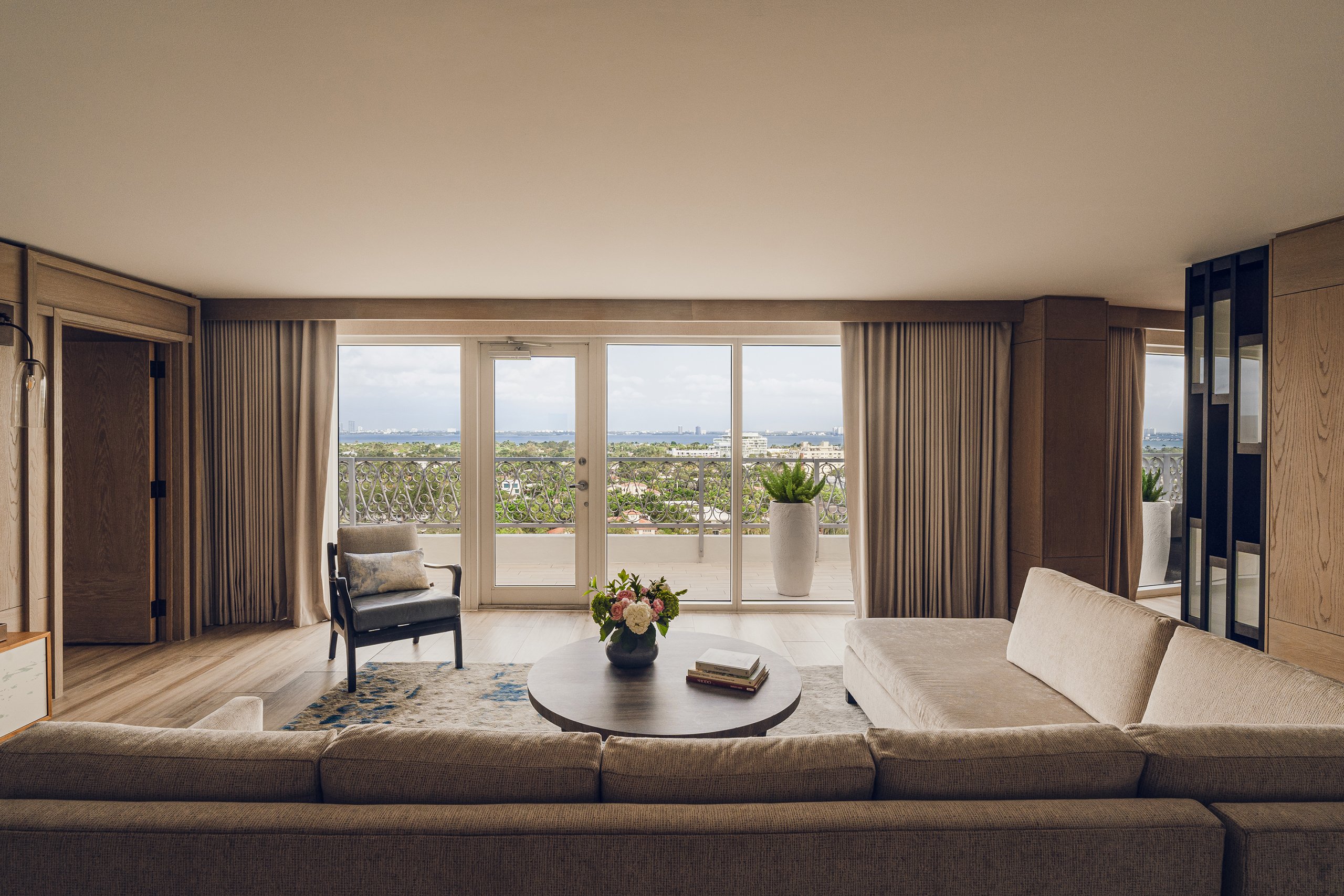 large comfortable couch and armchair with view from the balcony in living room