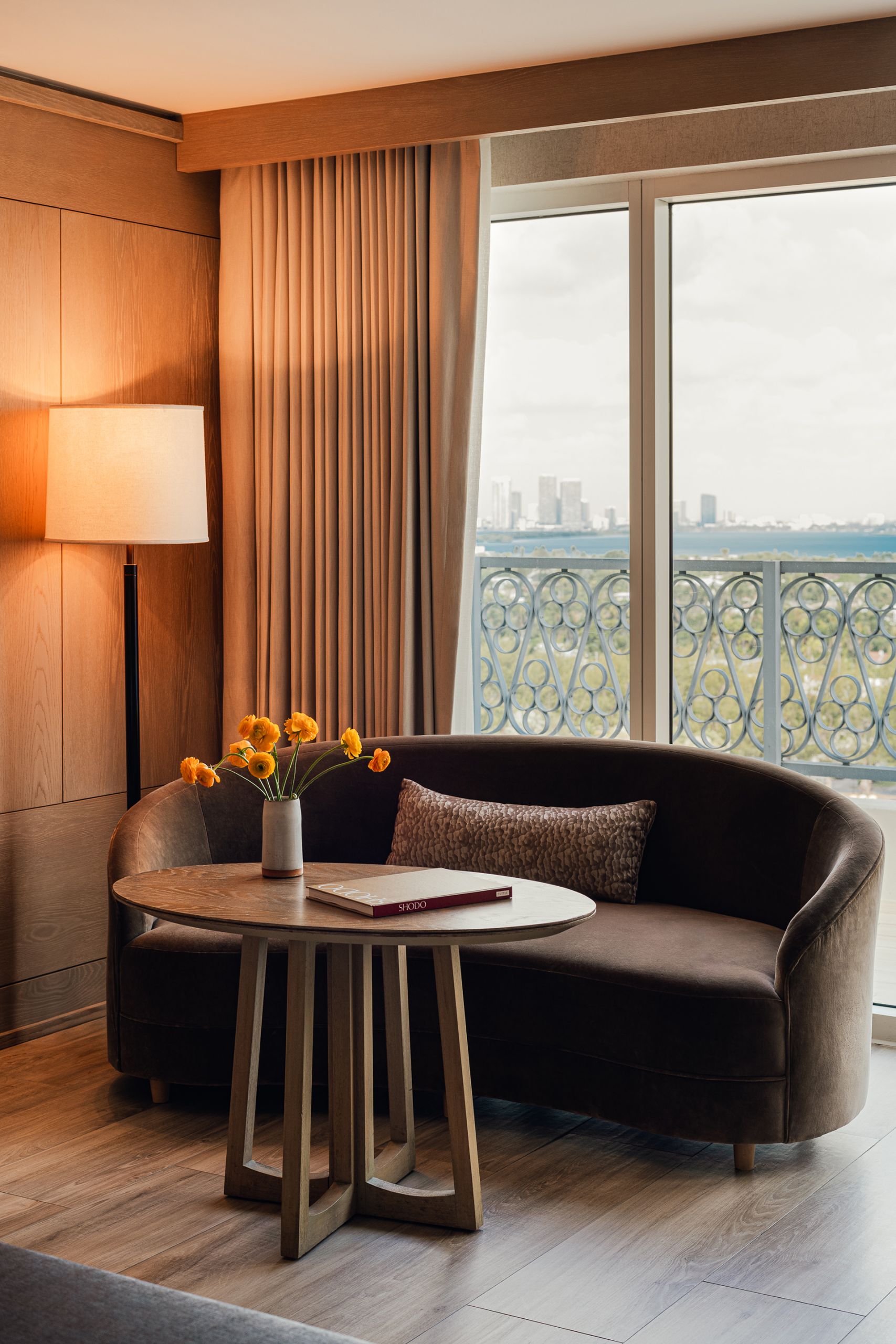 brown coloured couch and tea table with window from the balcony