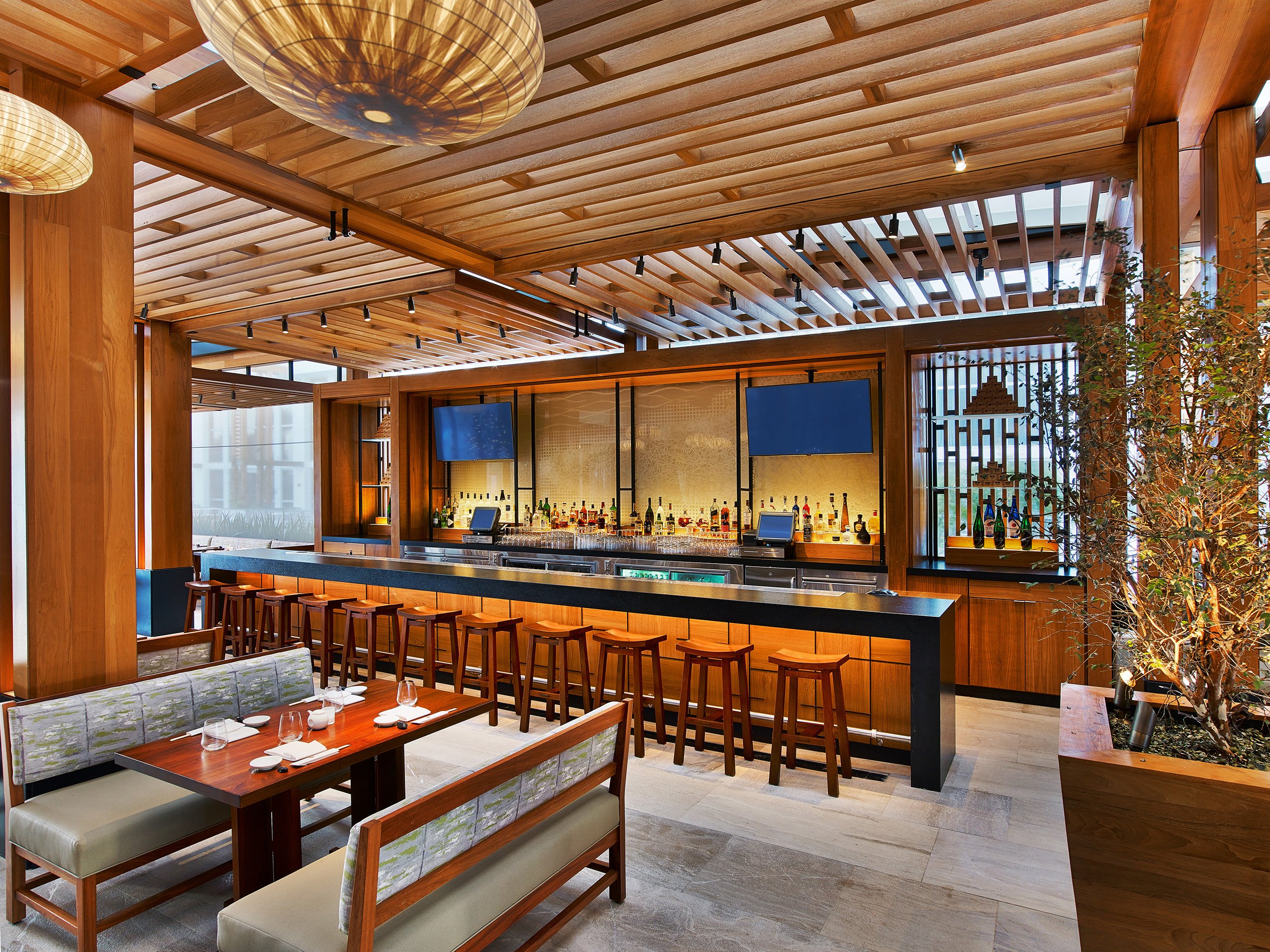 A vibrant restaurant showcasing a well-stocked bar and comfortable seating for a delightful dining experience