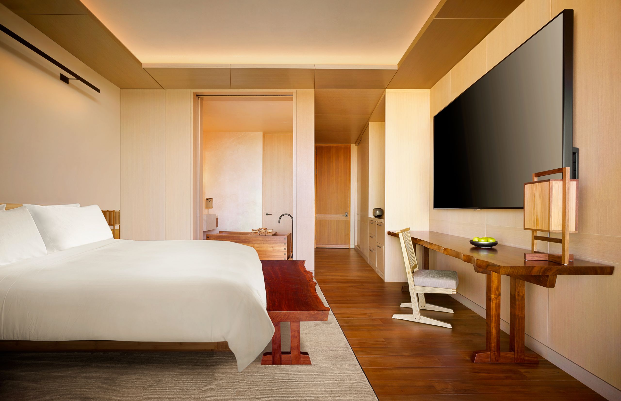 Nobu bedroom with opposite view of room. The bed is opposite a desk and the tv with a view of the washroom.