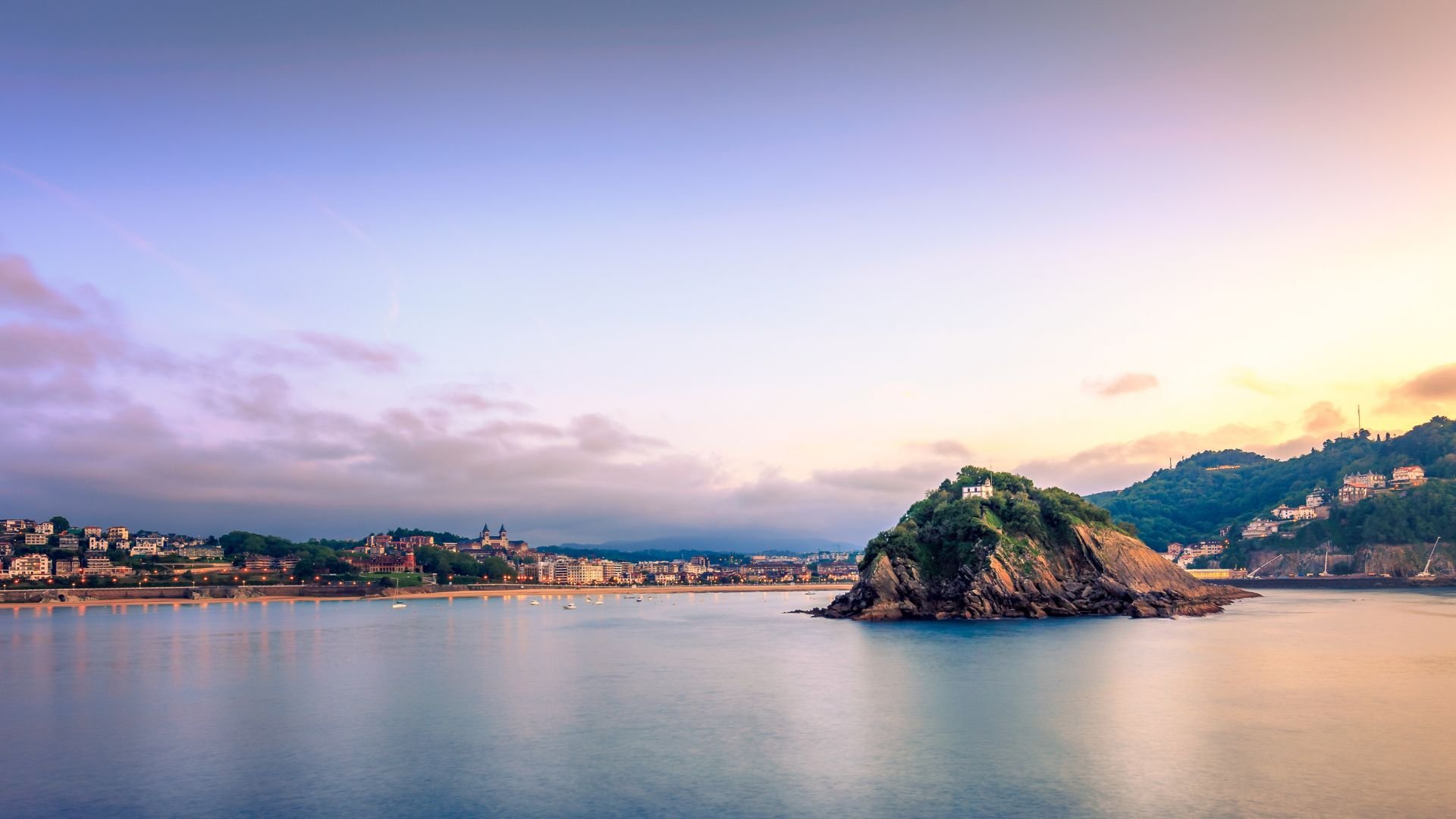 A tranquil small island in the ocean under beautiful sky, highlighting the coastal charm of San Sebastian