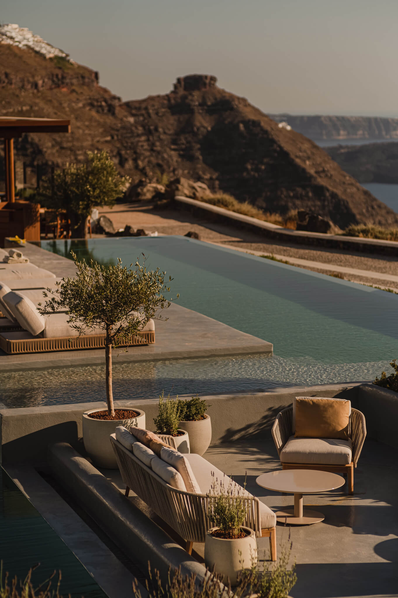 Lounge chairs by a beautiful pool provide a breathtaking ocean view, inviting relaxation and enjoyment of the coastal breeze