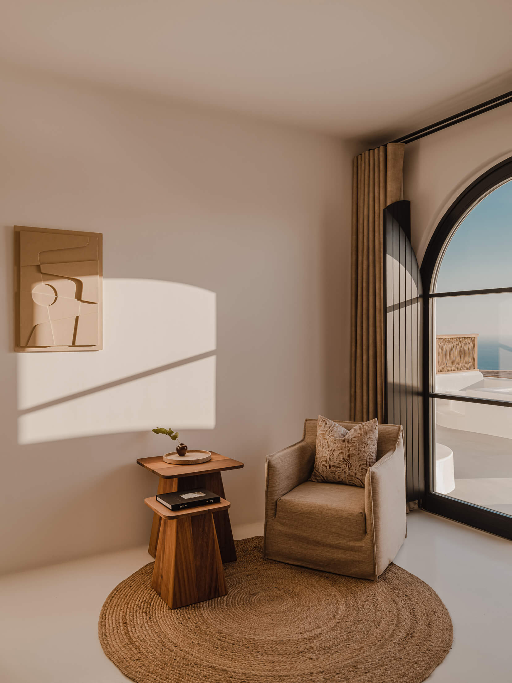 A charming room showcasing a chair and table placed before a large window, filled with natural light