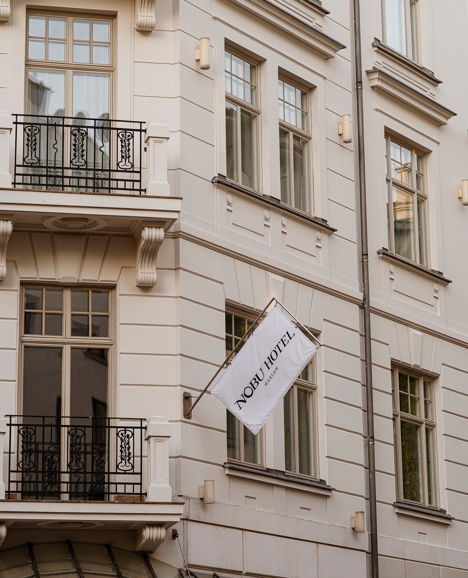 A contemporary white structure adorned with elegant black balconies, creating a striking visual appeal.