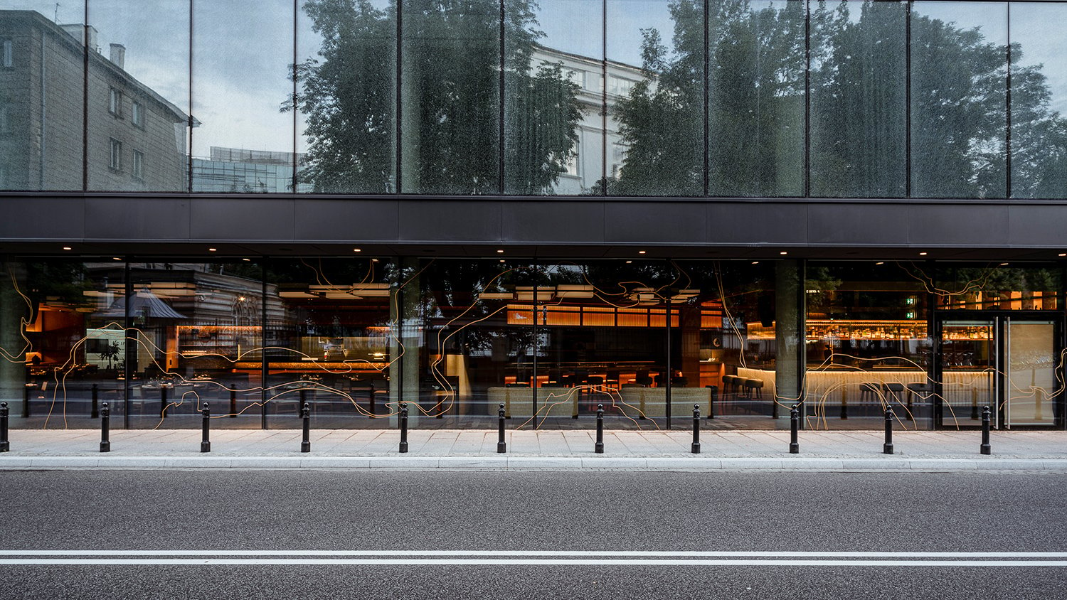 A modern restaurant featuring a large glass wall, offering a bright and inviting atmosphere for diners.