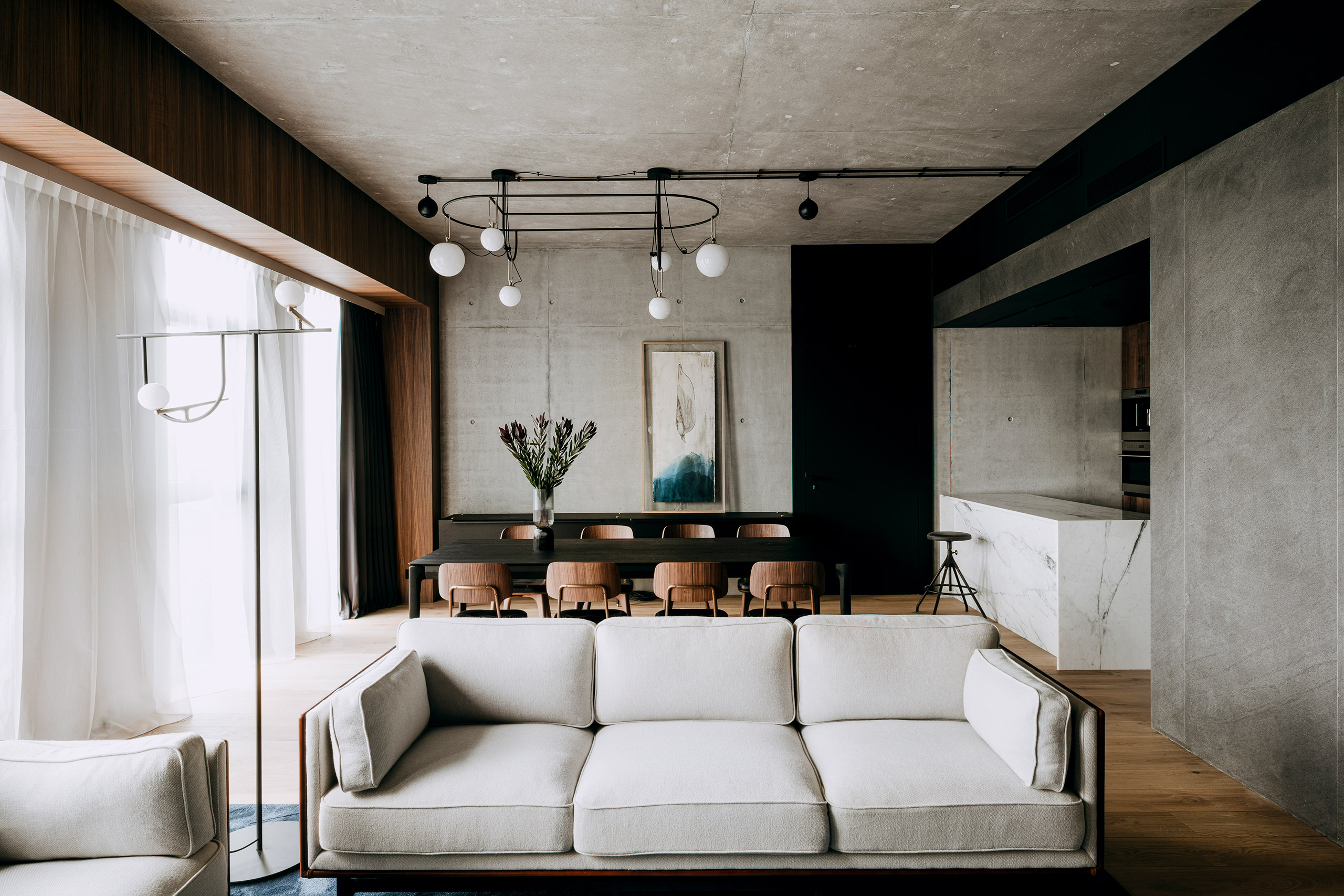 A stylish modern living room featuring a cozy couch and sleek chairs